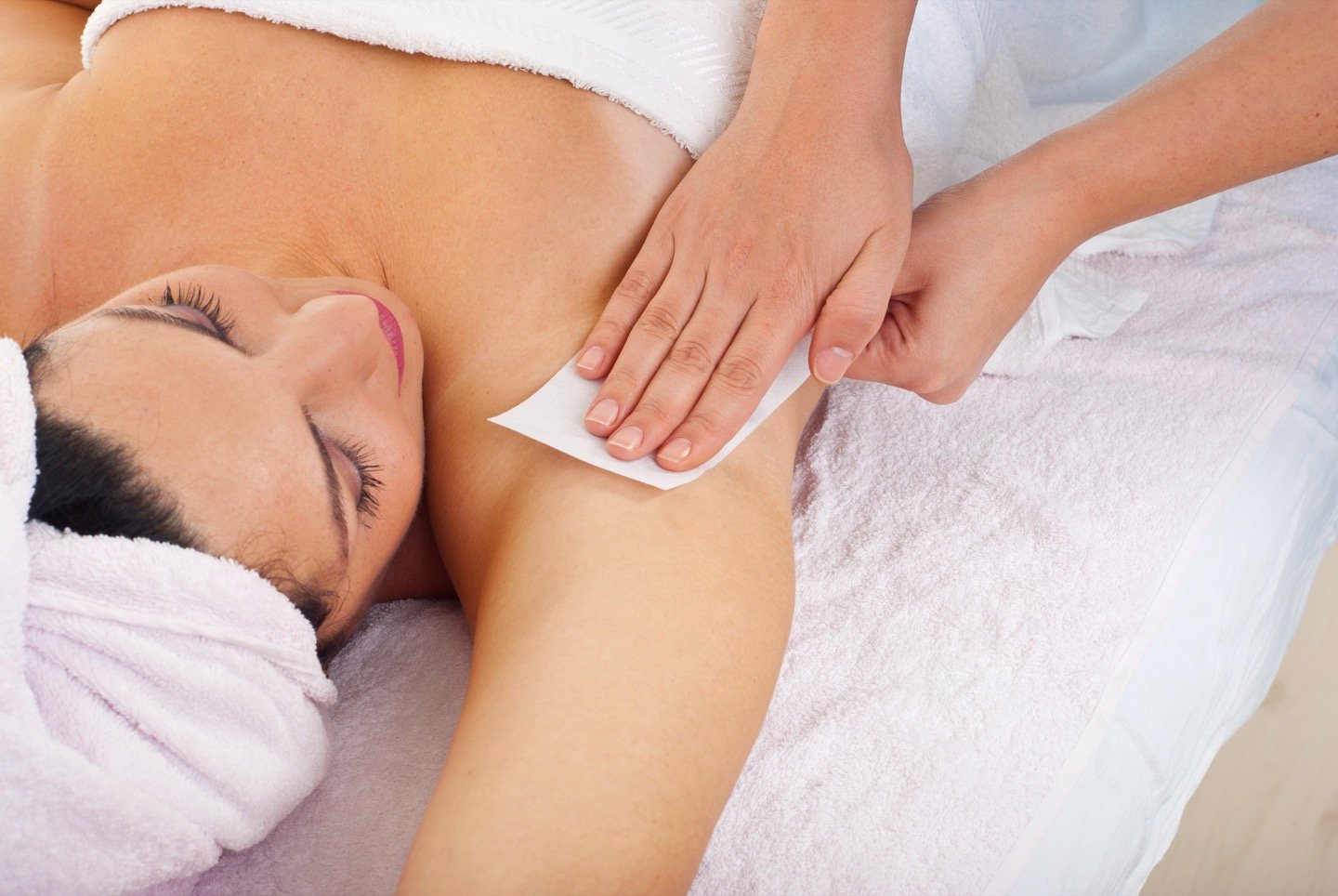 image of woman getting armpit waxed